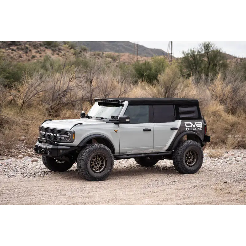 White jeep with black roof and wheels featuring DV8 21-22 Ford Bronco A-Pillar Pod Light Mounts.