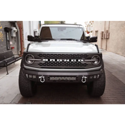White truck parked on street with DV8 21-22 Ford Bronco A-Pillar Pod Light Mounts