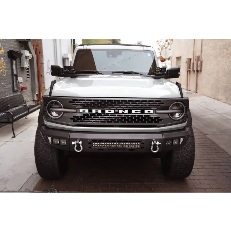 White truck parked on street with DV8 21-22 Ford Bronco A-Pillar Pod Light Mounts