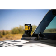 DV8 21-22 Ford Bronco A-Pillar Pod Light Mounts featuring a yellow pod light on a truck.