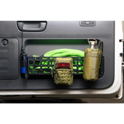 Green hose and water bottle in the back of a truck with DV8 Offroad 03-09 Lexus GX 470 Molle Door Pocket.