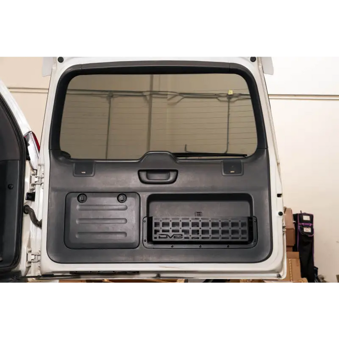 DV8 Offroad Molle Door Pocket installed on the rear panel of a vehicle