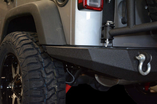 Close-up of dv8 offroad 07-18 jeep wrangler jk full-width rear bumper with tire