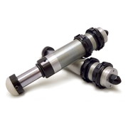 Pair of black metal hydraulic bump stops on white surface