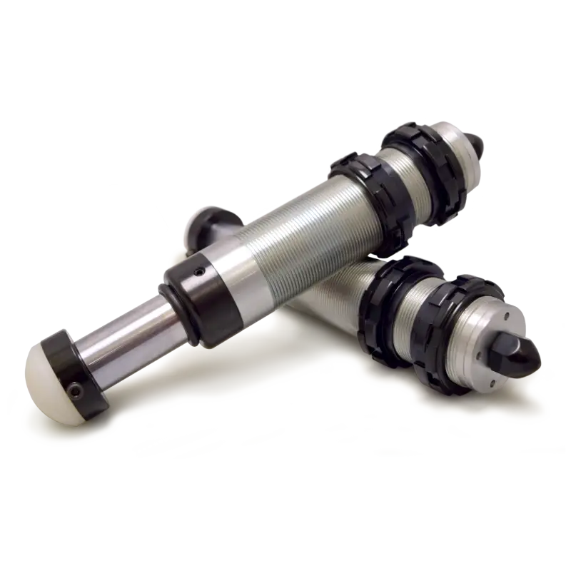 Pair of black metal hydraulic bump stops on white surface