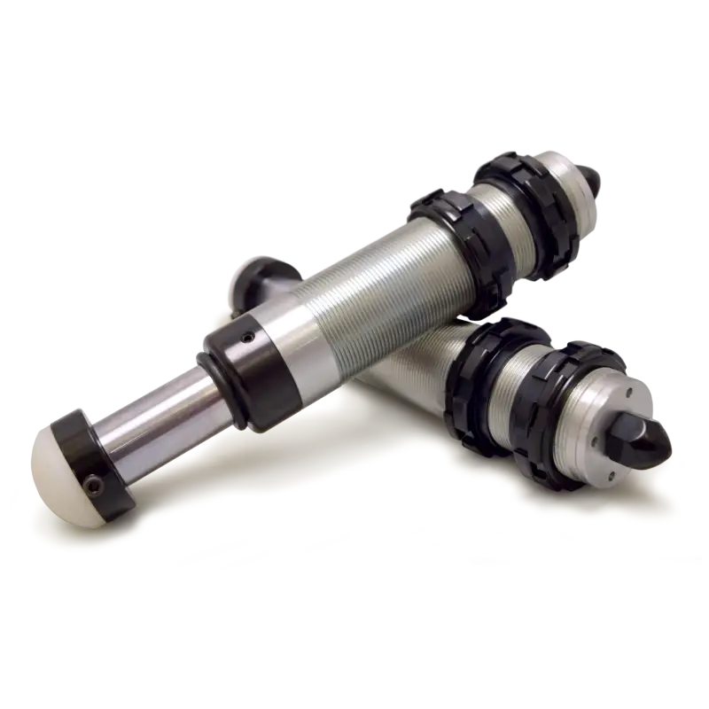 Pair of metal and black cylinders bump stops for Jeep Wrangler JK on white surface.