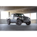 Black jeep parked in garage, dv8 offroad mto series front bumper for jeep wrangler.