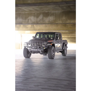 Dv8 offroad mto series front bumper on jeep wrangler parked in garage