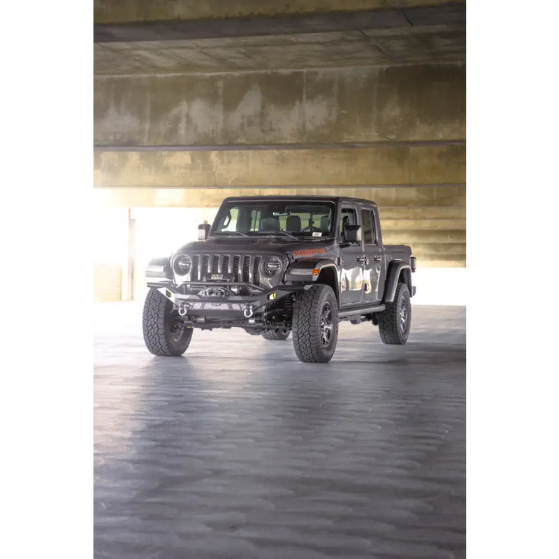 Dv8 offroad mto series front bumper on jeep wrangler parked in garage