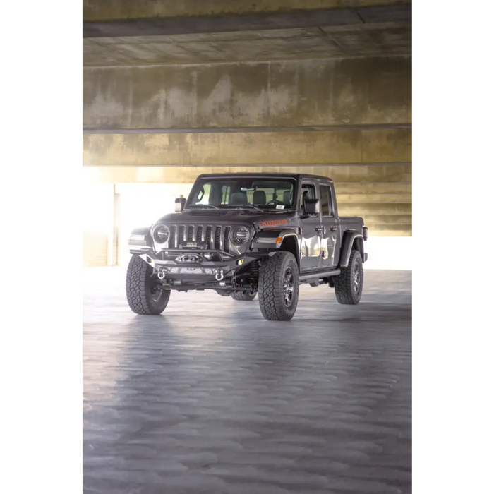 Dv8 offroad mto series front bumper on jeep wrangler parked in garage