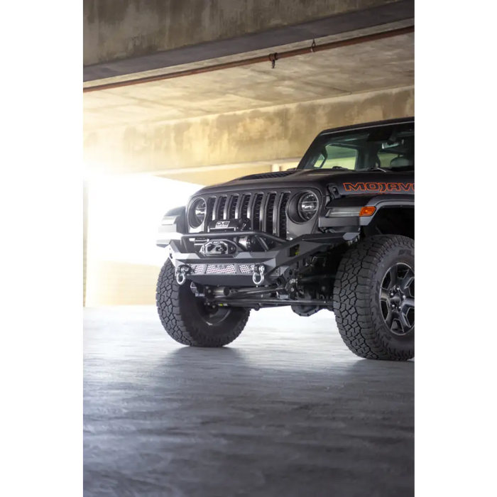 Dv8 offroad mto series front bumper on jeep wrangler parked in garage