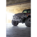 Dv8 offroad mto series front bumper on jeep wrangler parked in garage