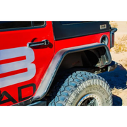 Red Jeep with bad logo on DV8 Offroad rear flat tube fenders