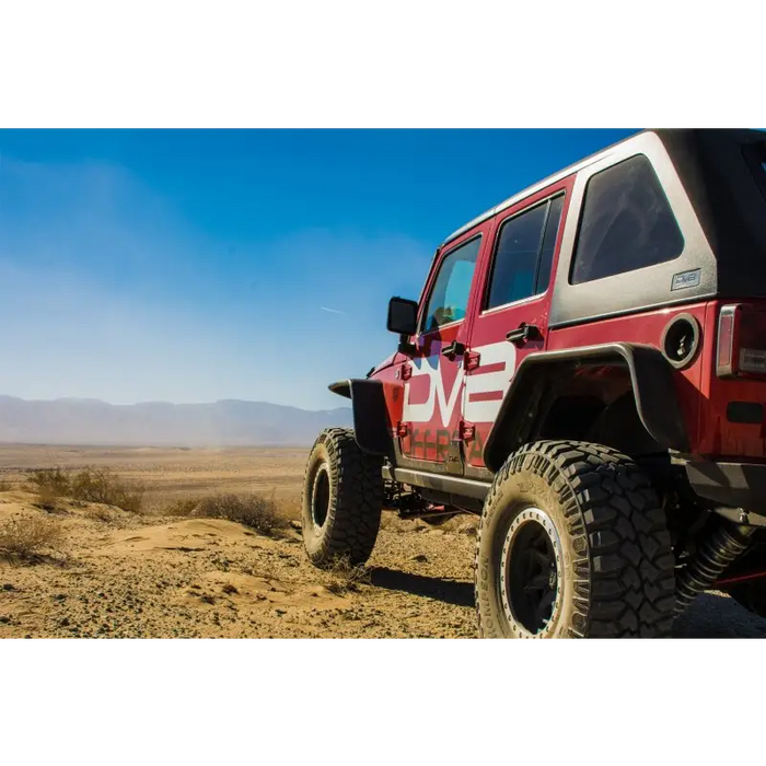 Red Jeep parked in desert, DV8 Offroad flat tube fenders