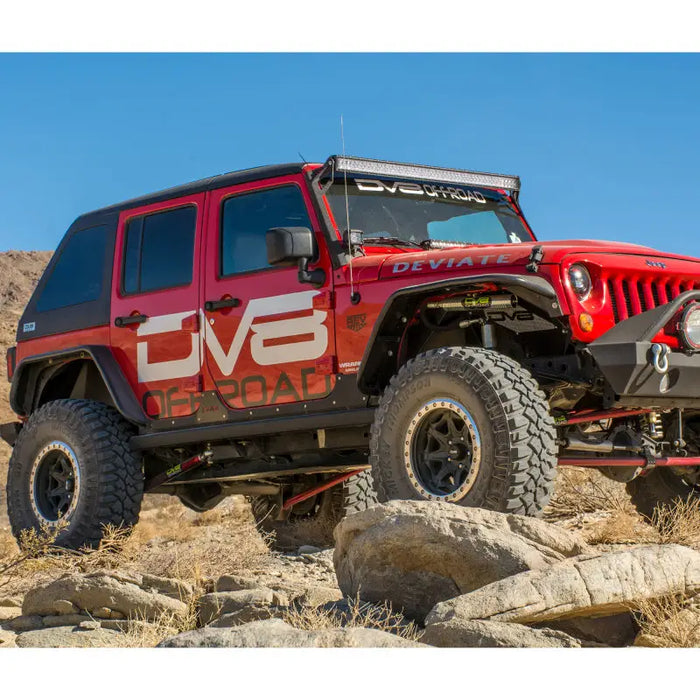 DV8 Offroad Jeep Wrangler JK Rear Flat Tube Fenders parked on desert rocks.