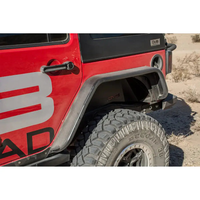 Red Jeep with bad logo on DV8 Offroad rear flat tube fenders