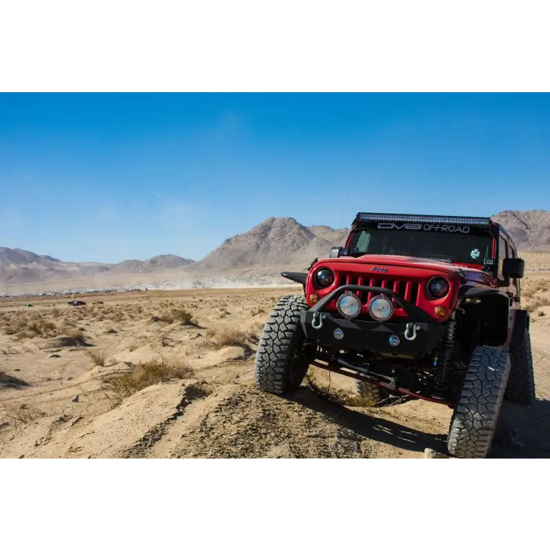 Red Jeep parked in desert with DV8 Offroad rear flat tube fenders.