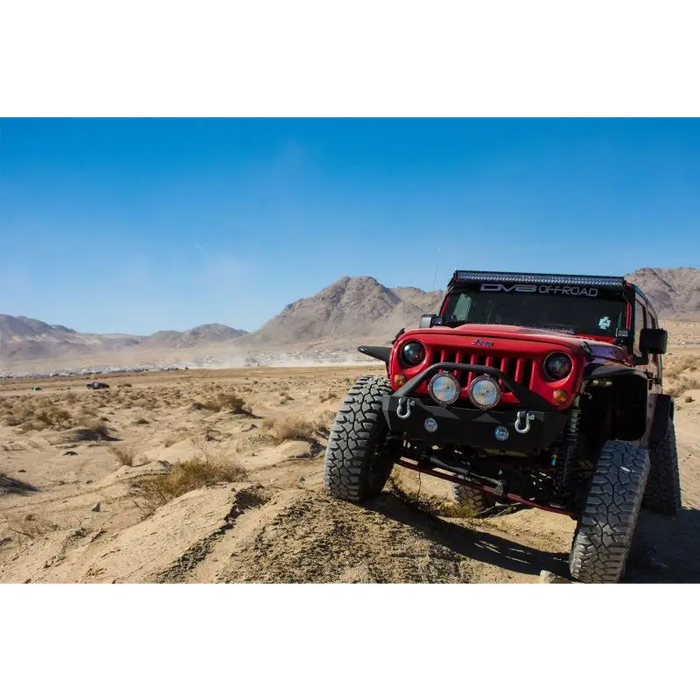 Red Jeep parked in desert with DV8 Offroad rear flat tube fenders.