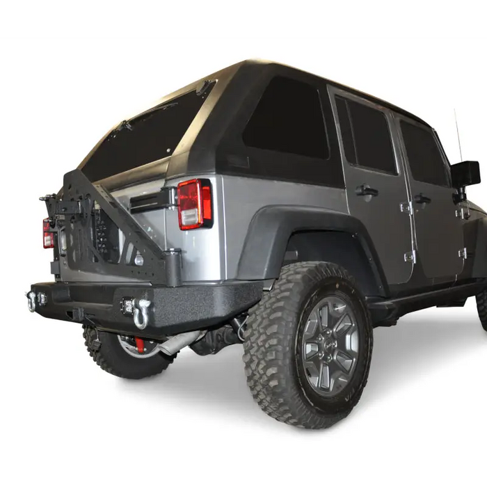 DV8 Offroad 07-18 Jeep Wrangler JK Full Length Rear Bumper with Light Holes - Close up of black top and silver tail light.
