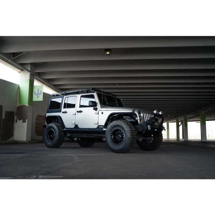 White Jeep Wrangler JK with black wheels and tires on DV8 Offroad Full-Length Roof Rack