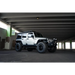 White Jeep Wrangler JK with black wheels and tires on DV8 Offroad Full-Length Roof Rack