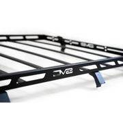 Close up of black metal rack with VW logo on DV8 Offroad Jeep Wrangler JK full-length roof rack.