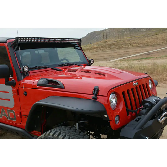 Red Jeep Wrangler parked on side of the road