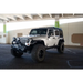 DV8 Offroad Short Roof Rack for Jeep Wrangler JK with white Jeep and black wheels.
