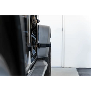 Man using machine to craft metal with DV8 Offroad Jeep Gladiator/Wrangler foot pegs.