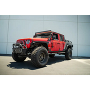 Red Jeep with black top and tires: DV8 Offroad hinge mounted step for Jeep Gladiator/Wrangler JT/JK/JL.