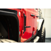 Red Jeep with black bumper and tire in DV8 Offroad 07-23 Jeep Gladiator/Wrangler hinge mounted step