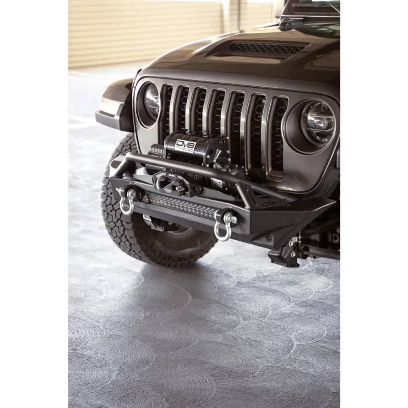 DV8 Offroad front bumper mounted on Jeep Wrangler for enhanced recovery options.