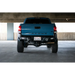 Blue truck parked in garage featuring DV8 Offroad 16-23 Toyota Tacoma MTO Series Rear Bumper.