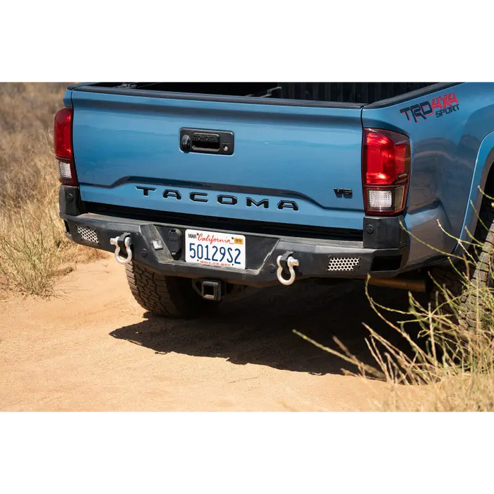 Blue truck parked on a dirt road - DV8 Offroad 16-23 Toyota Tacoma MTO Series Rear Bumper