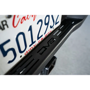 Close up of motorcycle license plate on DV8 Offroad Toyota Tacoma MTO Series rear bumper