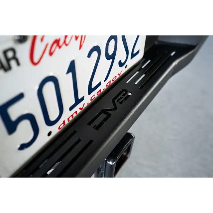 Close up of motorcycle license plate on DV8 Offroad Toyota Tacoma MTO Series rear bumper