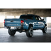 Blue truck parked in parking garage next to DV8 Offroad 16-23 Toyota Tacoma MTO Series rear bumper.