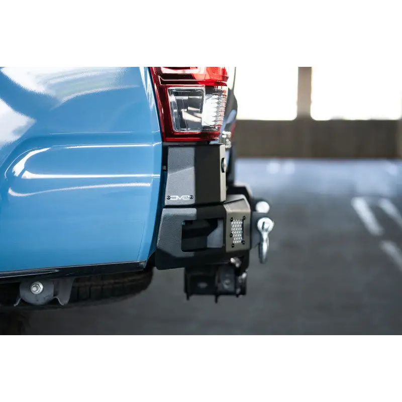Blue pickup truck rear end with DV8 Offroad 16-23 Toyota Tacoma MTO Series Rear Bumper