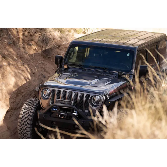 Jeep Gladiator JT driving through dirt with cowl light bar bracket.