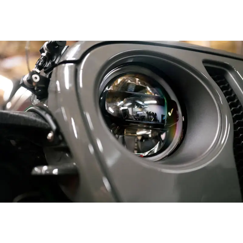 Close up of front end motorcycle LED projector headlights for Jeep Wrangler DV8 Offroad product.