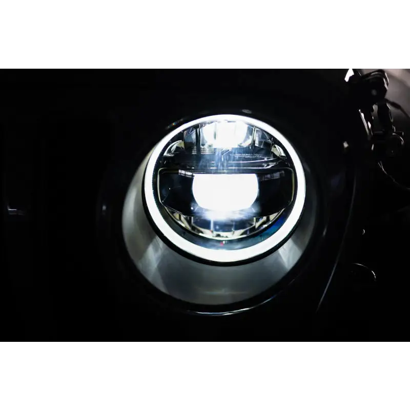 Close-up of DV8 Offroad LED projector headlights for Jeep Wrangler.