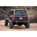 DV8 Offroad spare tire delete kit with large tire on dirt road