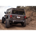 Jeep Wrangler driving down steep hill with spare tire delete kit.