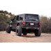 DV8 Offroad spare tire delete kit featuring black Jeep rear end with bumper.