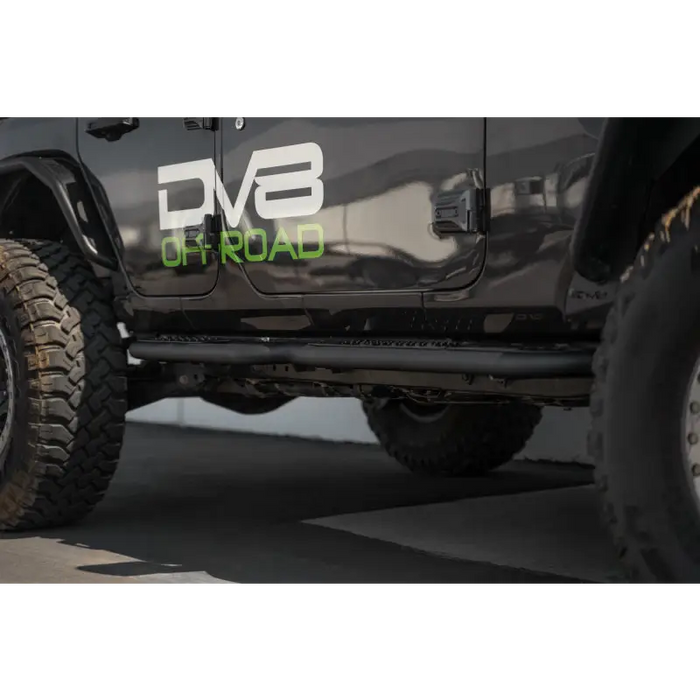 Black Jeep with green logo on DV8 Offroad 18-23 Jeep Wrangler JL 4 Door Body/Pinch Weld Mounted Step.
