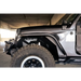 Black Jeep with tire cover parked in garage, featured on DV8 Offroad 18-23 Jeep Wrangler JL Slim Fender Flares.