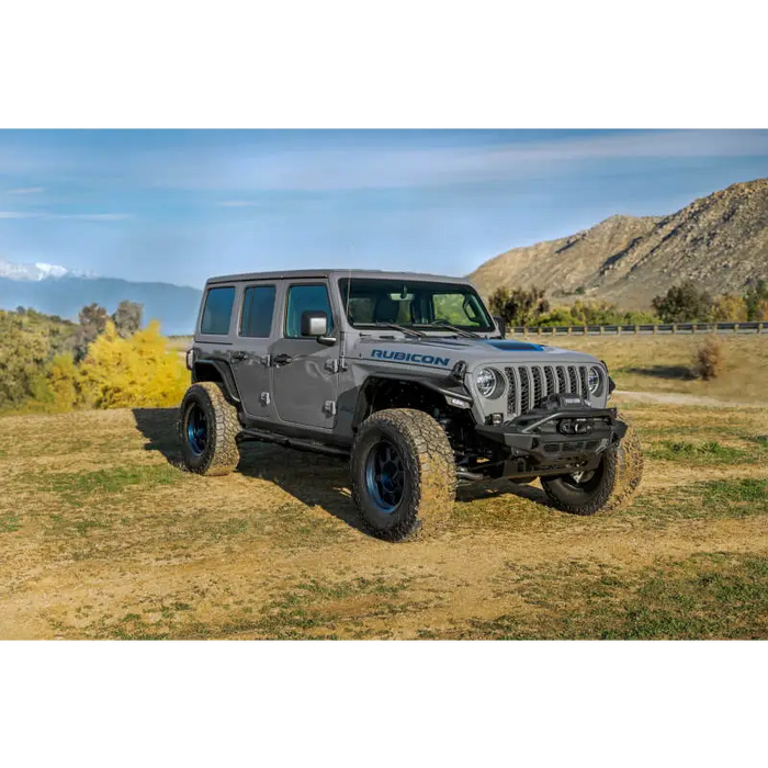 DV8 Offroad Jeep Wrangler JL Spec Series Tube Fenders on a parked Jeep WRL in a field