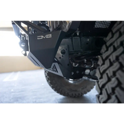 Close up of truck tire on DV8 Offroad Front Bumper with Sway Bar Disconnect Motor Skid Plate.