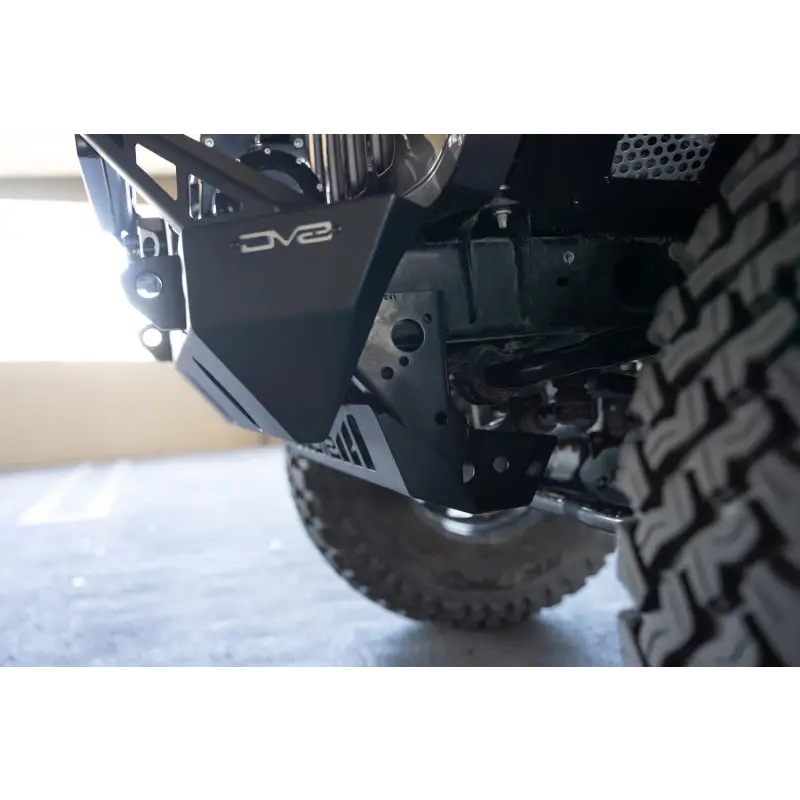 Close up of truck tire on DV8 Offroad Front Bumper with Sway Bar Disconnect Motor Skid Plate.