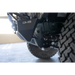 Close up of truck tire on DV8 Offroad Front Bumper with Sway Bar Disconnect Motor Skid Plate.